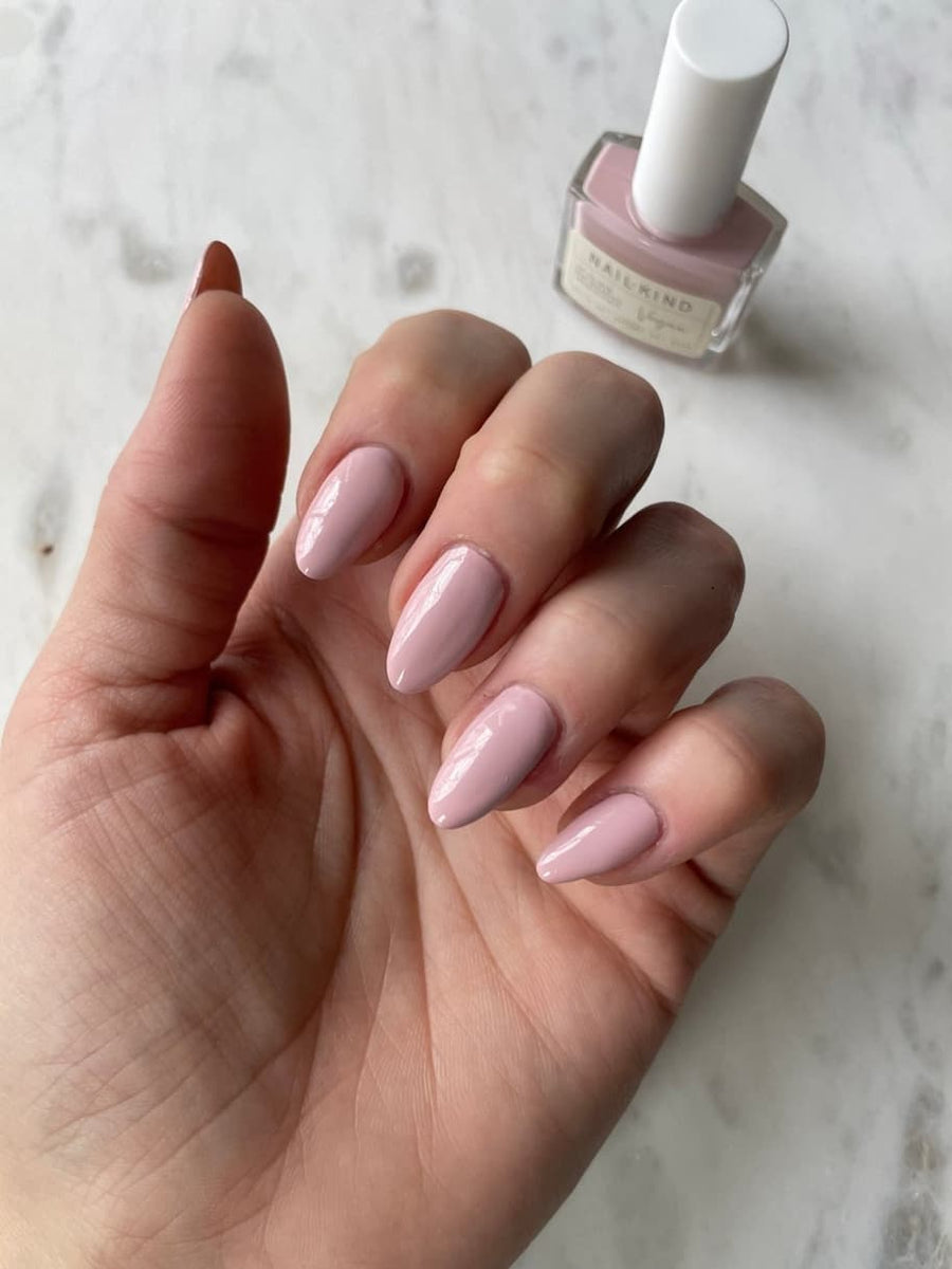 Soft pink NailKind nail polish on almond nails
